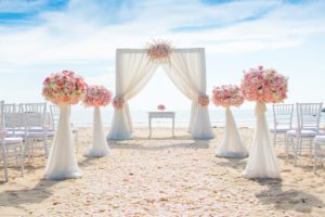 Flowers and drapery on beach for wedding