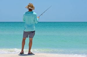 Man Fishing off the Beach