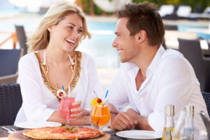 Couple enjoying dinner and drinks on vacation