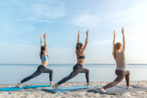 Yoga class on a sunny beach