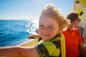 Boy smiling on boat 