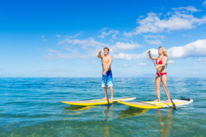 Boy and girl on yellow paddleboards