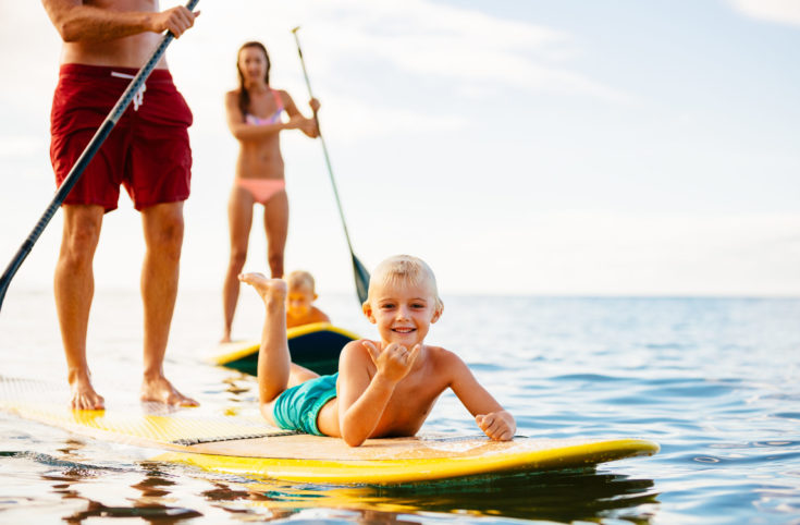 Family,Having,Fun,Stand,Up,Paddling,Together,In,The,Ocean