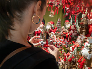 Woman looking at Christmas ornaments and decor
