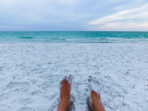 Feet in the white quartz sand on Siesta Key beach