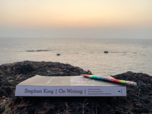 Stephen King's book On Writing placed on rocks at the beach