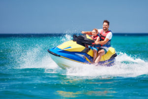 Happy father and son on a jet ski