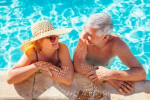 Retired senior couple enjoying the pool together
