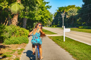 Girl riding beach bike on vacation
