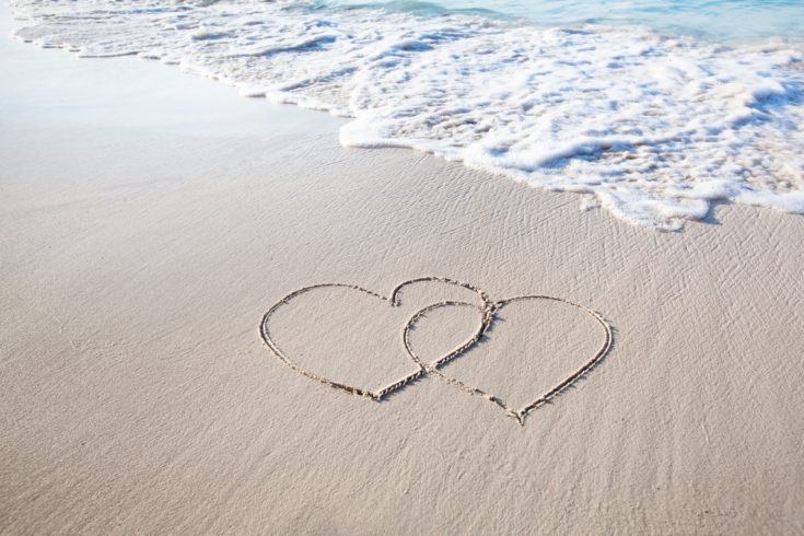 Two,Hearts,Drawn,On,Perfectly,White,Sand,Of,Paradise,Beach