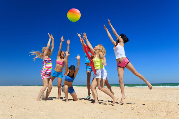 Group,Of,Young,Joyful,Girls,Playing,Volleyball,On,The,Beach