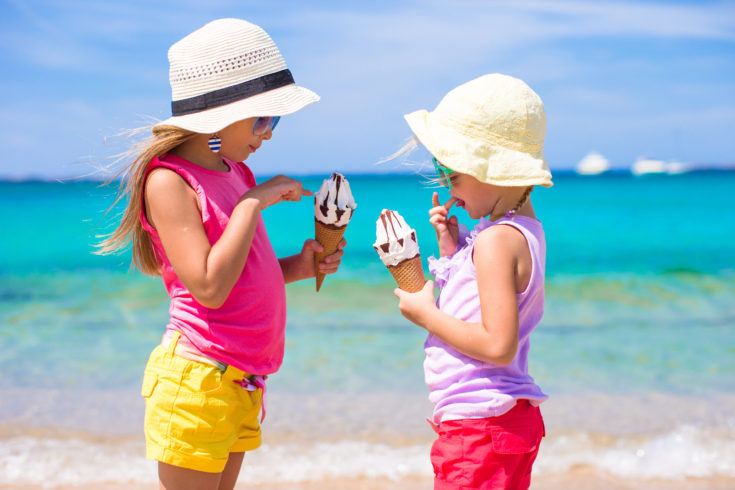 Happy,Little,Girls,Eating,Ice-cream,Over,Summer,Beach,Background.,People,