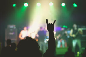 Man giving horns at rock concert