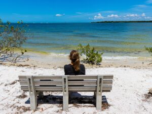 Woman sitting on bench at De Soto National Memorial